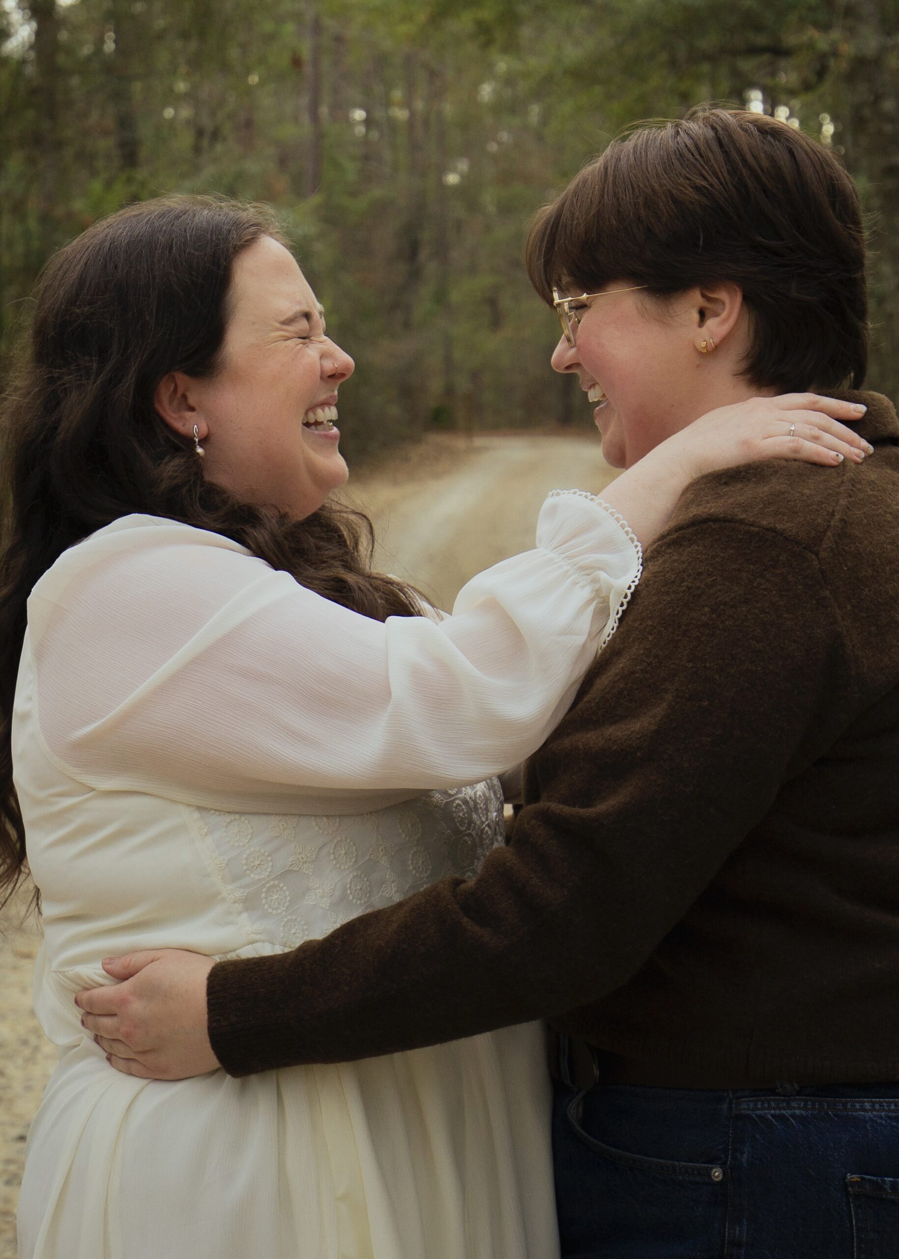 A couple holds each other and laughs