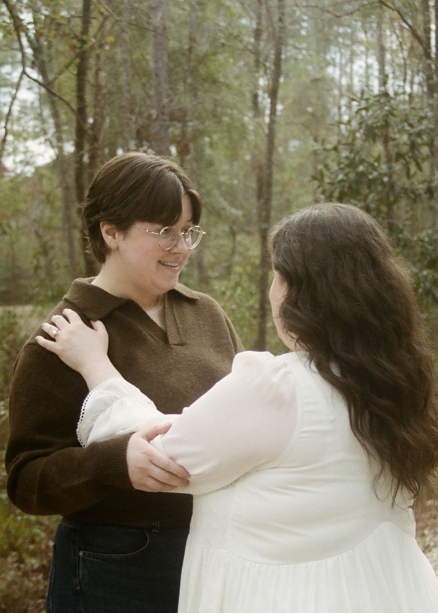 Film photo f a couple holding each other and talking, just after getting engaged