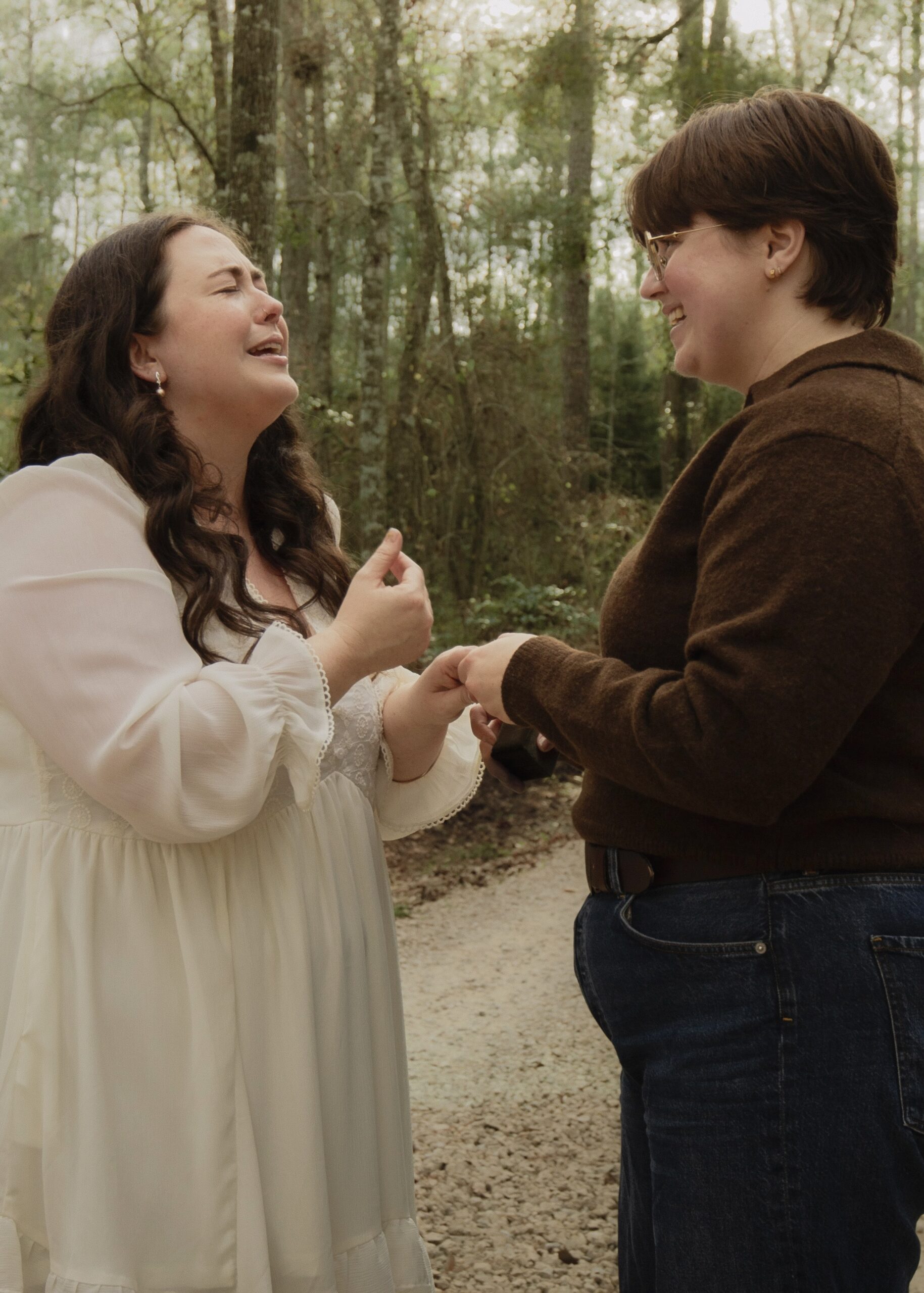A couple, overcome with joy and excitement after getting engaged