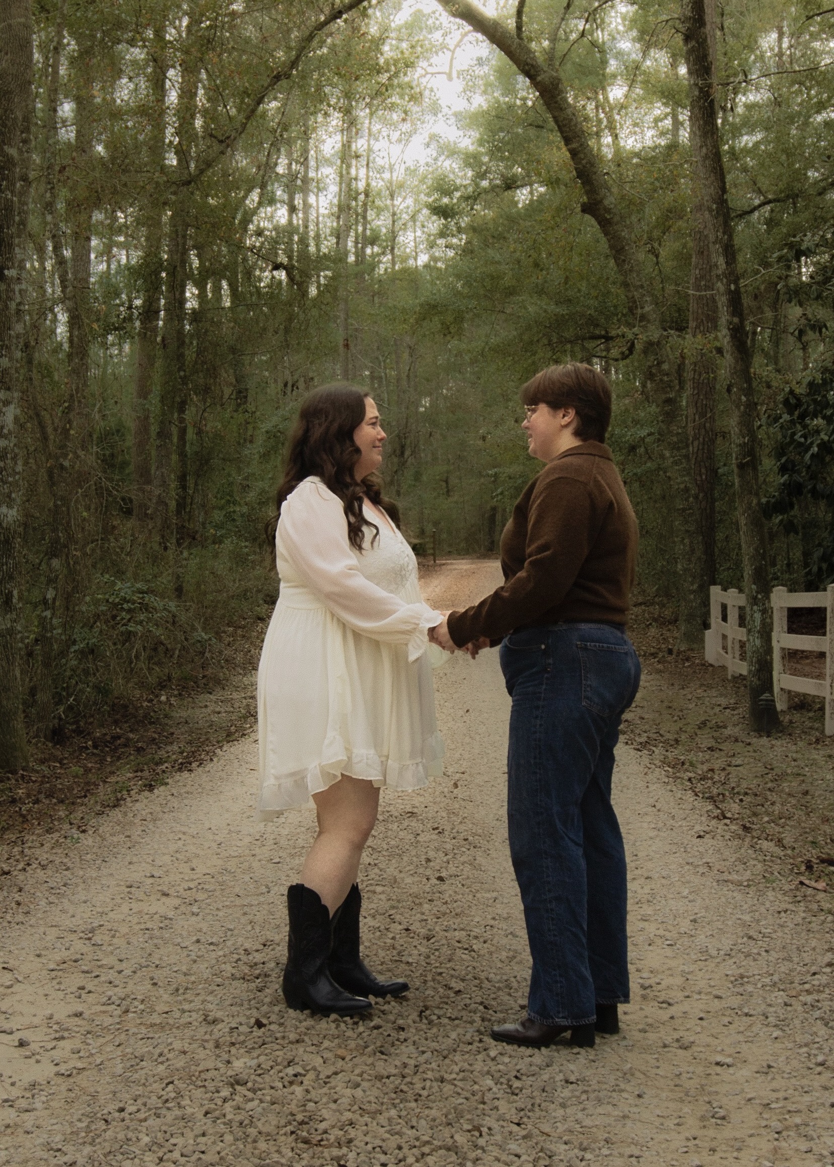 A lesbian couple holds hands as a proposal begins