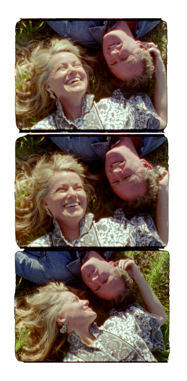 A super8 film reel of a couple laughing and laying in a meadow
