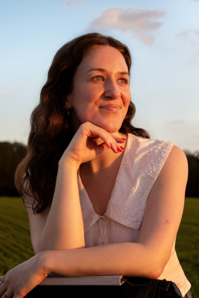 Headshot of an author in a field in golden light