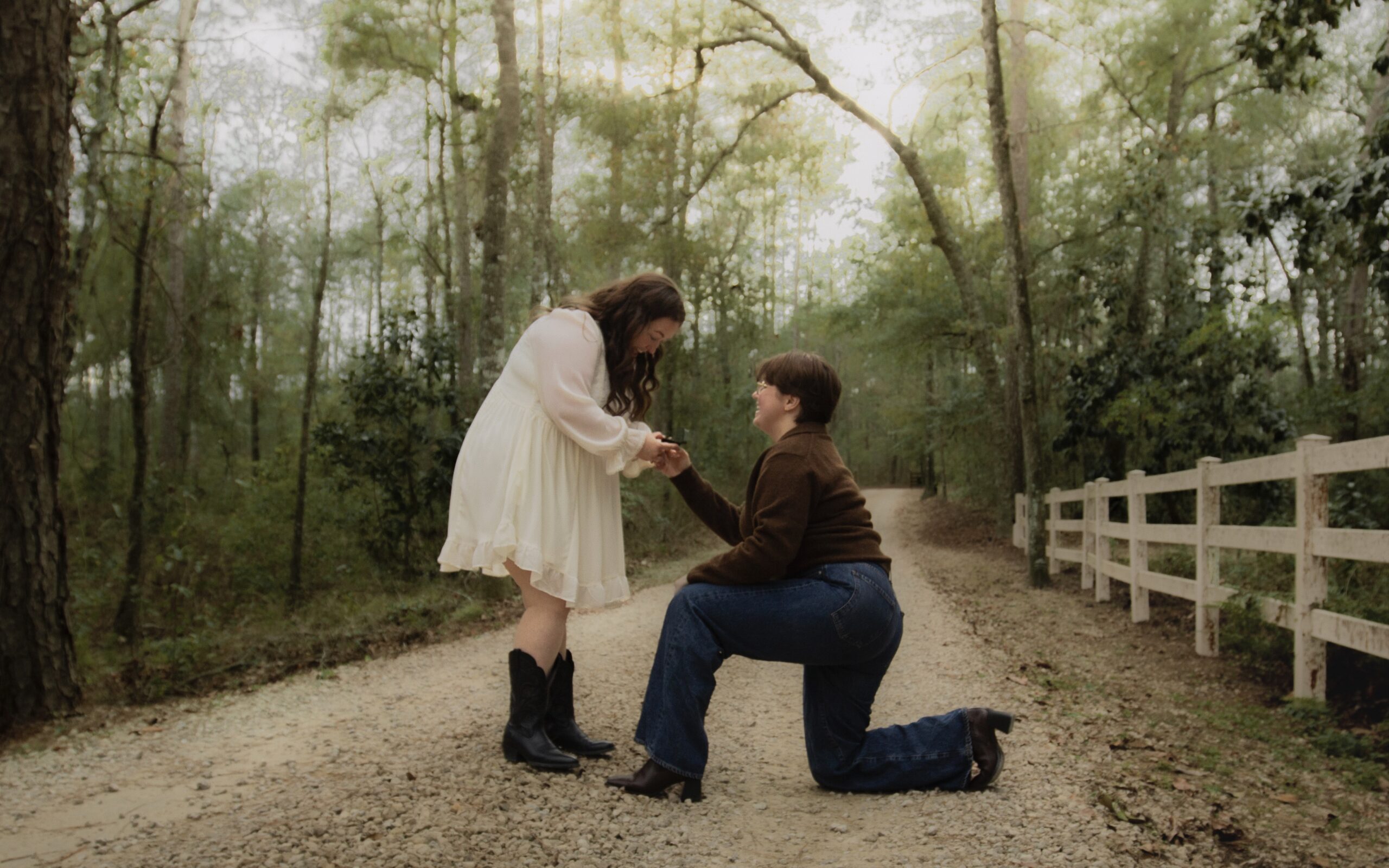 A lesbian proposal on a lane surrounded by trees
